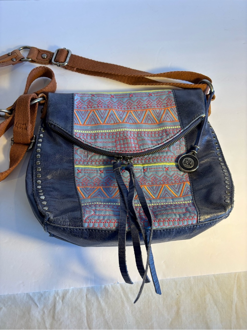 The Sak Navy Multicolor Embroidered Crossbody Bag with Brown Strap